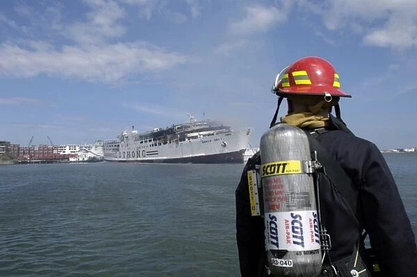 A U. S. Navy Sailor responds to a shipboard fire