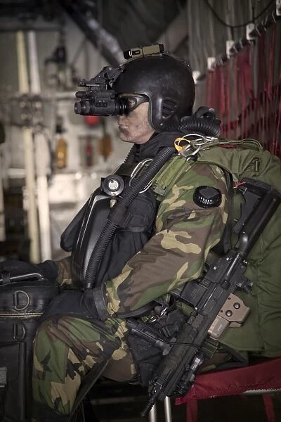 U. S. Navy Seal equipped with night vision prepares for HALO jump operations