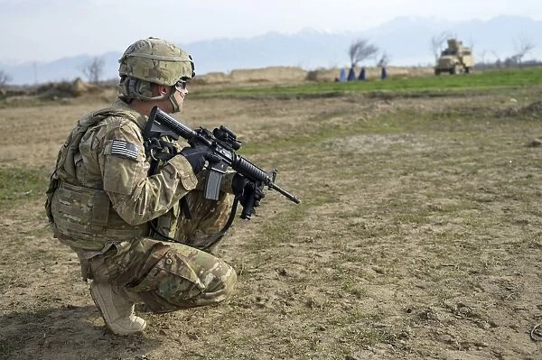 U. S. Soldier patrols a village in Afghanistan