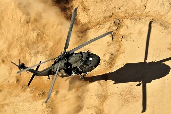A UH-60 Black Hawk helicopter comes in for a dust landing