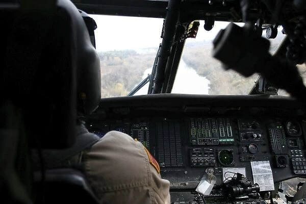 A UH-60 Blackhawk flies the river to an unknown village to drop off a care package