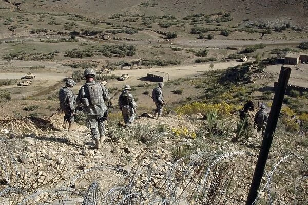 U.s Army Soldiers walk back to their humvee from a border checkpoint