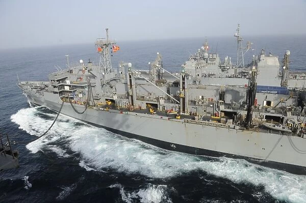 USNS Rainier transits alongside USS Nimitz during a replenishment at sea