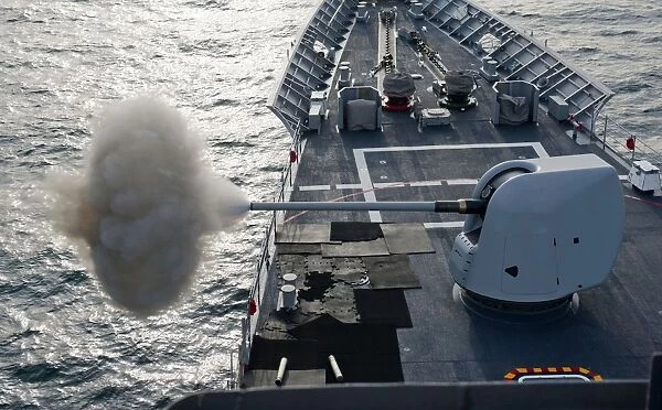 USS Cape St. George fires its MK-45 lightweight 5-inch gun