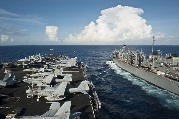 USS Nimitz and USNS Rainer transit alongside each other