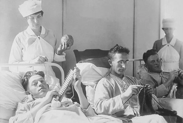 Wounded soldiers knitting under the watchful eye of nurses