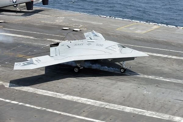 An X-47B Unmanned Combat Air System makes an arrested landing