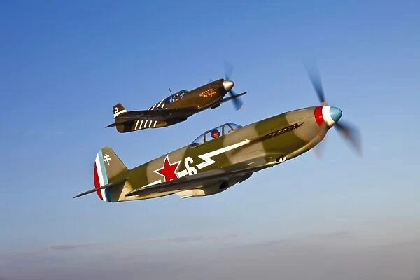 A Yakovlev Yak-9 fighter plane and a P-51A Mustang in flight