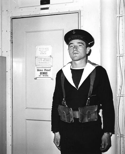 A French sentry outside the operations room of the aircraft carrier La Fayette, 1951