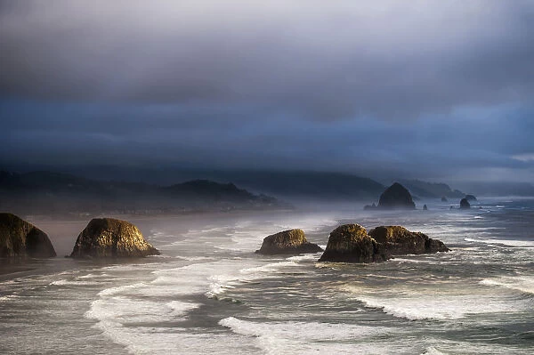 Sunlight And Mist Create Coastal Moods; Cannon Beach, Oregon, United States Of America