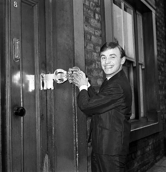 Gerry Marsden opens the door to his house on his 21st birthday 1963