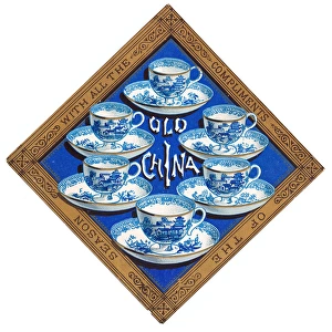 Blue and white china cups and saucers on a Christmas card