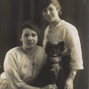 Studio portrait, two young women with dog