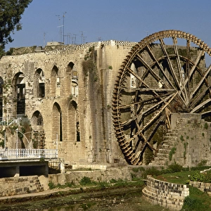 Syria. Hama. Noria in the Orontes river next to the aqueduct