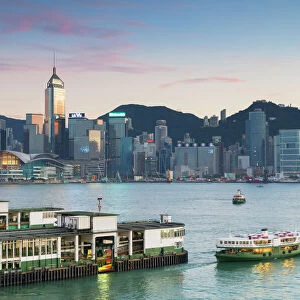 View of Star Ferry Terminal and Hong Kong Island skyline at dusk, Hong Kong, China, Asia