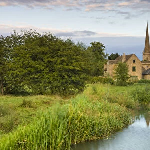 Burford Mill and Church viewed from the River Windrush in the water meadows, Burford