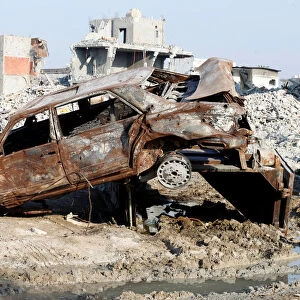 Remains of a car and buildings are seen following a security campaign against Shi ite