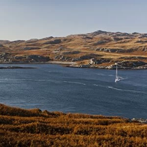 View of yacht on sea loch, view across to Ruantallan from Tarbert Estate, Loch Tarbert, Isle of Jura, Inner Hebrides