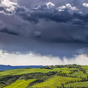 Europe, Italy, Val d Orcia. Storm clouds over Tuscany landscape