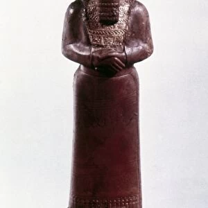 ASSYRIAN STATUE. Assyrian royal statue (Ashurnasirpal?) of amber. 9th century B. C