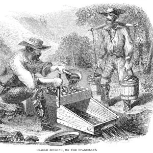 CALIFORNIA GOLD RUSH, 1860. A gold miner using a cradle rocker on the Stanislaus River in California. Wood engraving, 1860