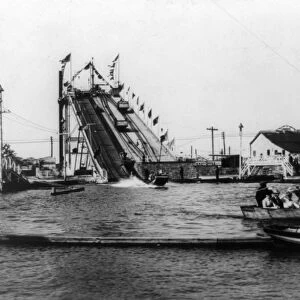 CONEY ISLAND: LUNA PARK. Boat with nine people in foreground riding The Chutes