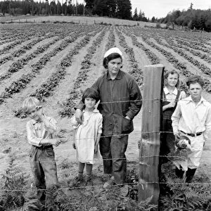 FARM FAMILY, 1939. A mother and her four children in front of their newly fenced