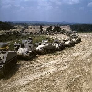 Parade of M-4 Sherman and M-3 Grant tanks during training maneuvers at Fort Knox, Kentucky. Photograph by Alfred T. Palmer, June 1942