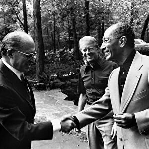 Prime Minister Menachem Begin of Israel (left) shakes hands with President Anwar Sadat of Egypt during their summit meeting in Camp David, Maryland, hosted by U. S. President Jimmy Carter (center), 7 September 1978