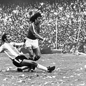 SOCCER MATCH, 1977. Kevin Keegan of England is tackled by an Argeninian defender during a soccer match in Buenos Aires, 12 June 1977