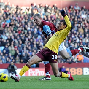 Marouane Chamakh scores Arsenals 3rd goal under pressure from Richard Dunne (Villa)