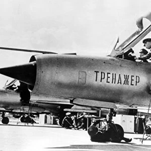 September 1966: a north vietnamese student pilot in a non-flying mig-21 fighter jet trainer, with him is his soviet flight instructor, lettering on fusilage: trainer