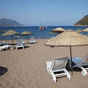 Turkey, sun loungers and palapas on Adrasan beach, near Kemer
