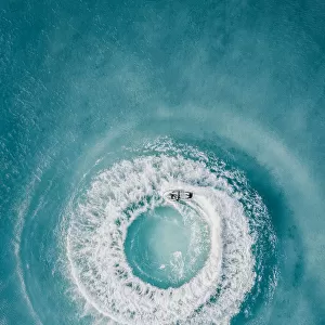 Circle patterns created by jet ski at sea as seen from directly above, Barbados