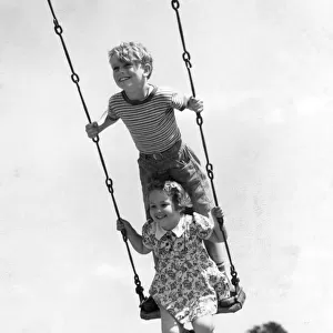Boy And Girl On Swing