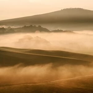 Hill layers with light and fog in Val d Orcia, Siena countryside