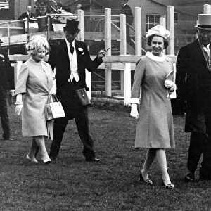 Queen Elizabeth II and her mother walk down the Epsom racecourse June 1971