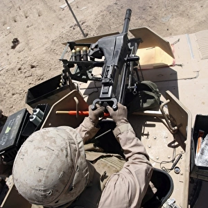 A 40 mm grenade flies from the muzzle of a MK-19 automatic grenade launcher
