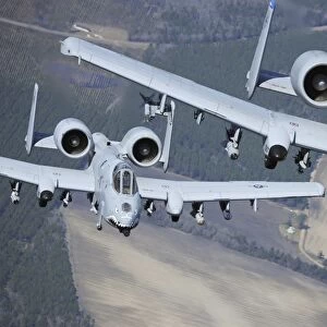 Two A-10C Thunderbolt II aircraft fly in formation