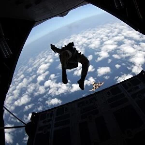 Air Force members practice jumping out of an Air Force C-130 Hercules