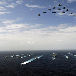 Aircraft fly over a group of U. S. and Japanese Maritime Self-Defense Force ships