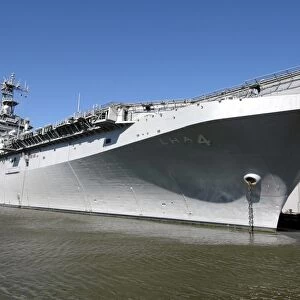 The amphibious assault ship USS Nassau sits moored in port
