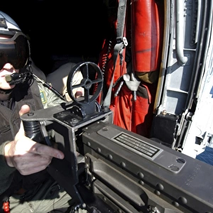 Aviation Warfare Systems Operator mans a. 50 caliber machine gun