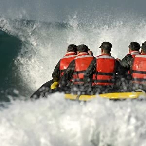 Basic Underwater Demolition / SEAL students encounter a large wave during a surf passage