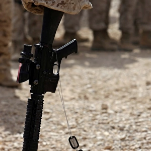Boots, a helmet, rifle and dog tags serve as a representation of the memory of a soldier