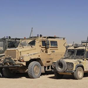 A British Armed Forces Snatch Land Rover parked next to other military vehicles