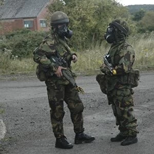 Two British soldiers in full NBC protection gear