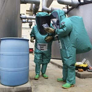 CBRN defense specialists check a barrel for contamination