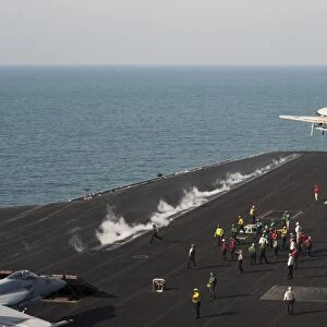 An E-2C Hawkeye launches from the flight deck of USS Harry S. Truman