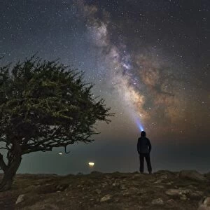 Explorer looking at the Milky Way from the coast of the Black Sea